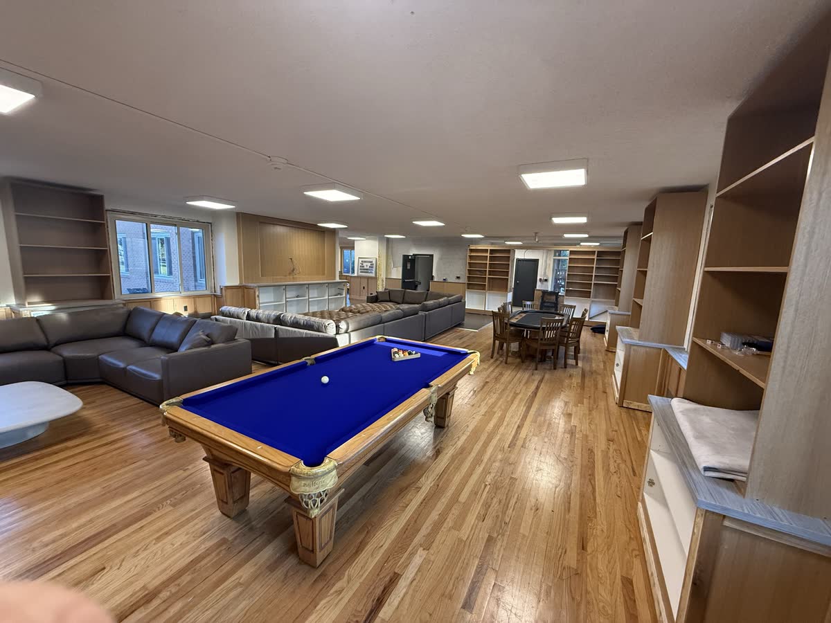 Great room wide view — pool table, sectionals, hardwood floors complete, August 21 2026