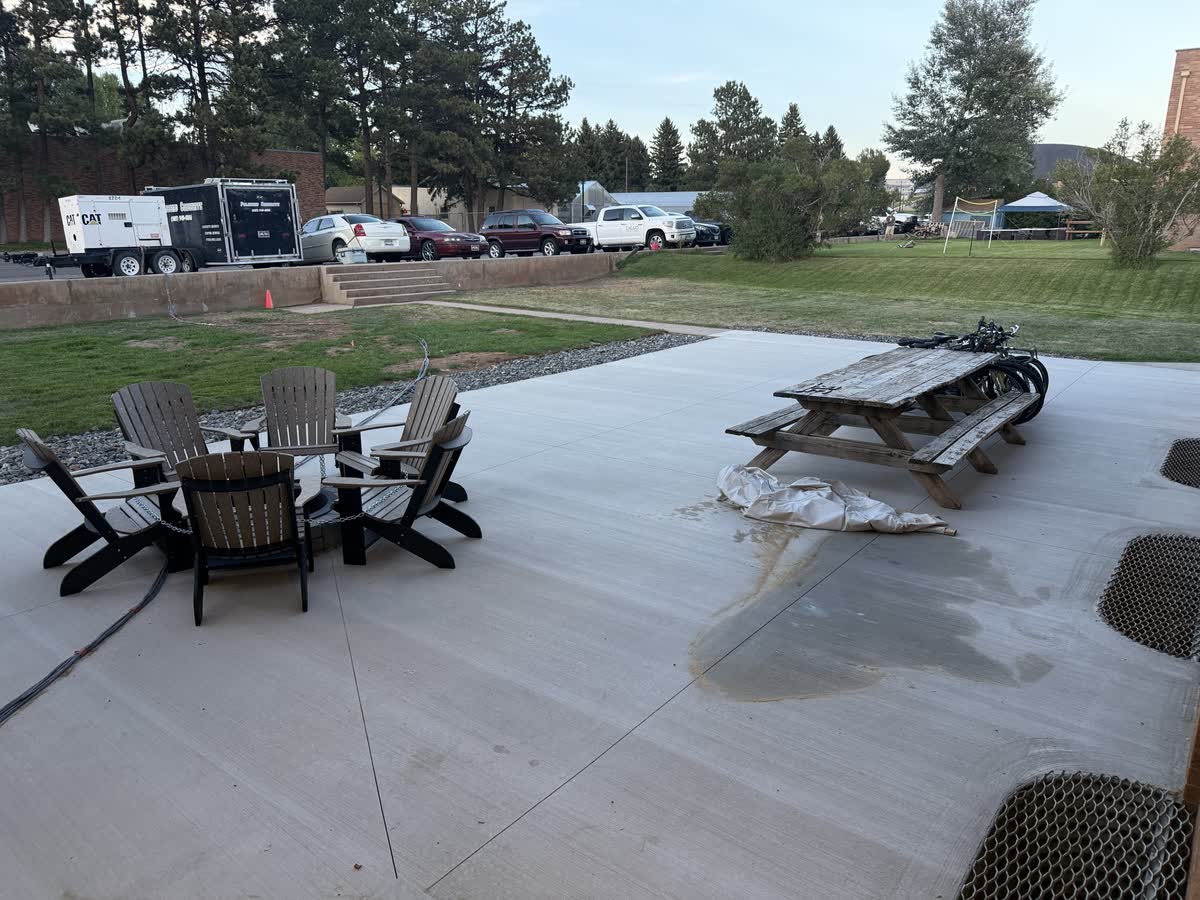 Back patio furnished with Adirondack chairs and fire pit, August 21 2026