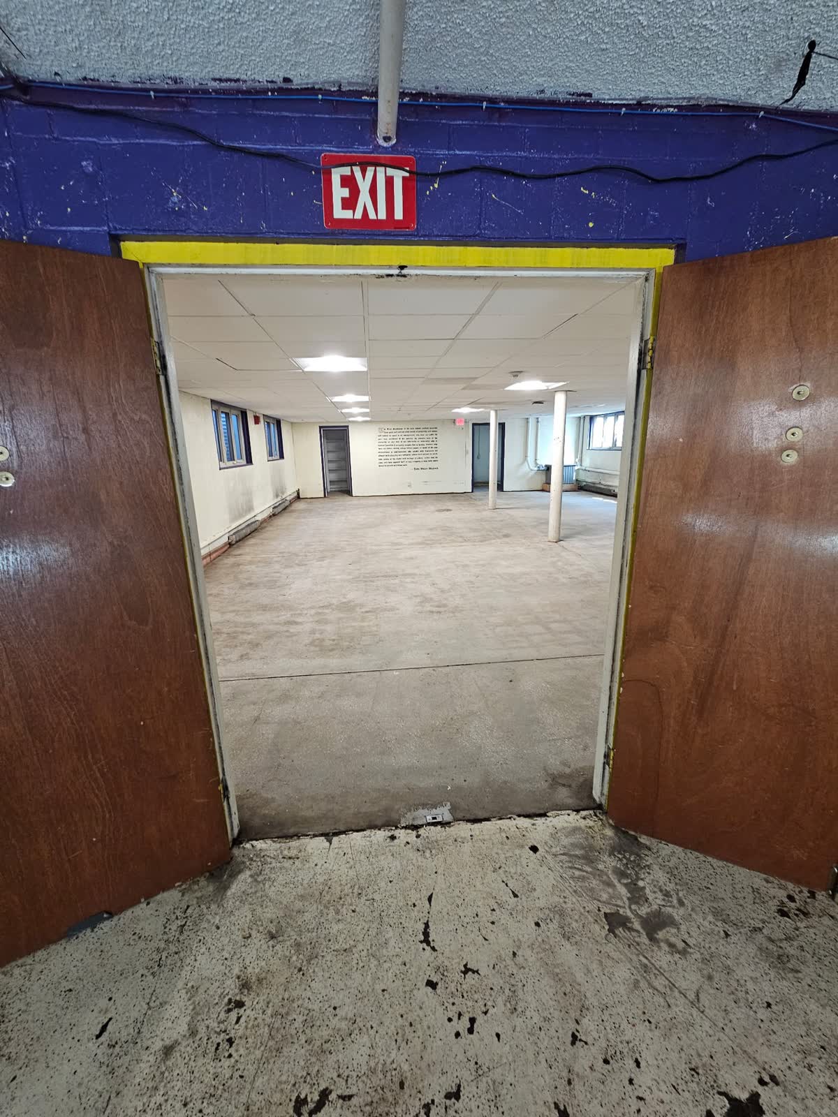 Chapter room entrance with old tile removed and bare subfloor exposed