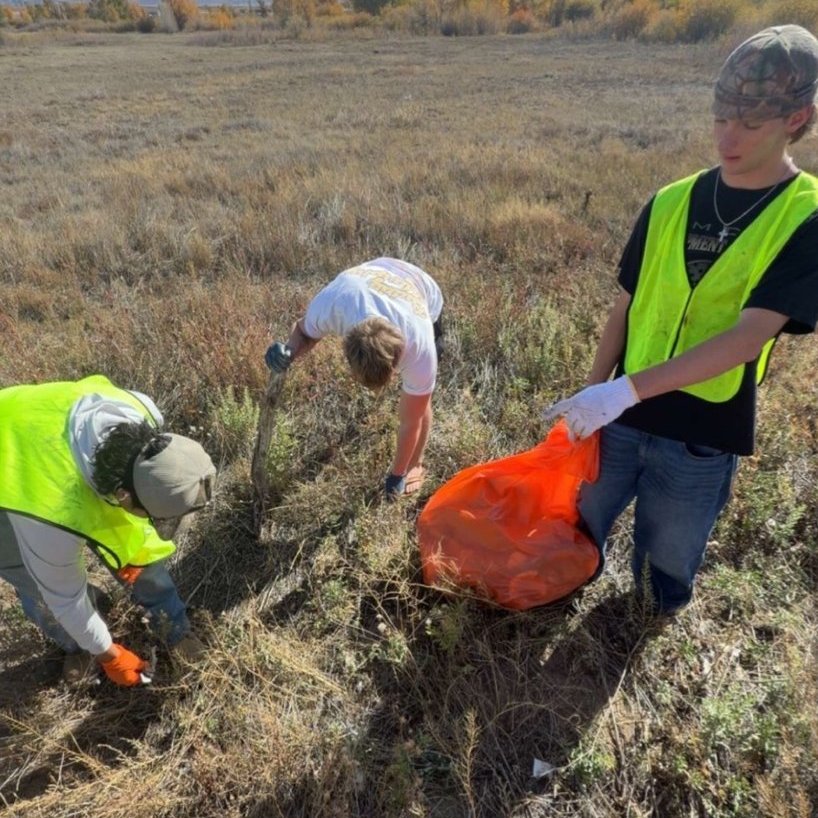 Brothers in safety vests on a community cleanup in Laramie