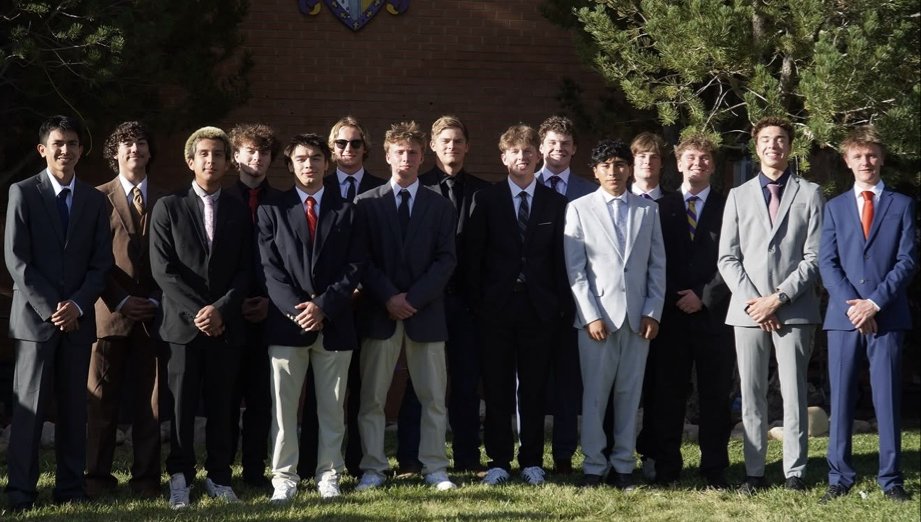 Fall 2026 new member class in suits outside the chapter house