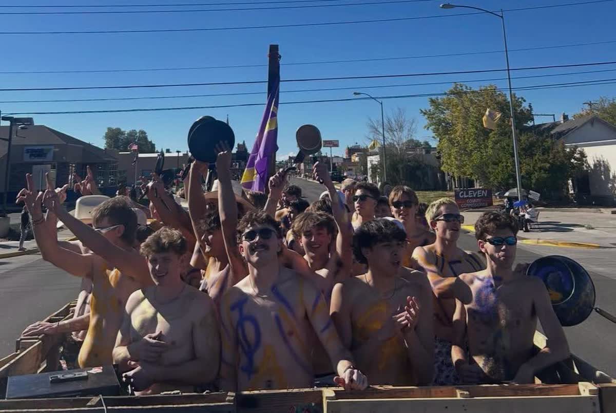 Brothers cheering on the chapter parade float in downtown Laramie